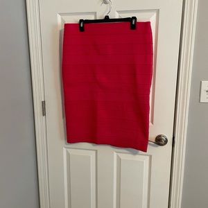Hot pink pencil skirt with back split. Bottom hem sits mid shin on petite person